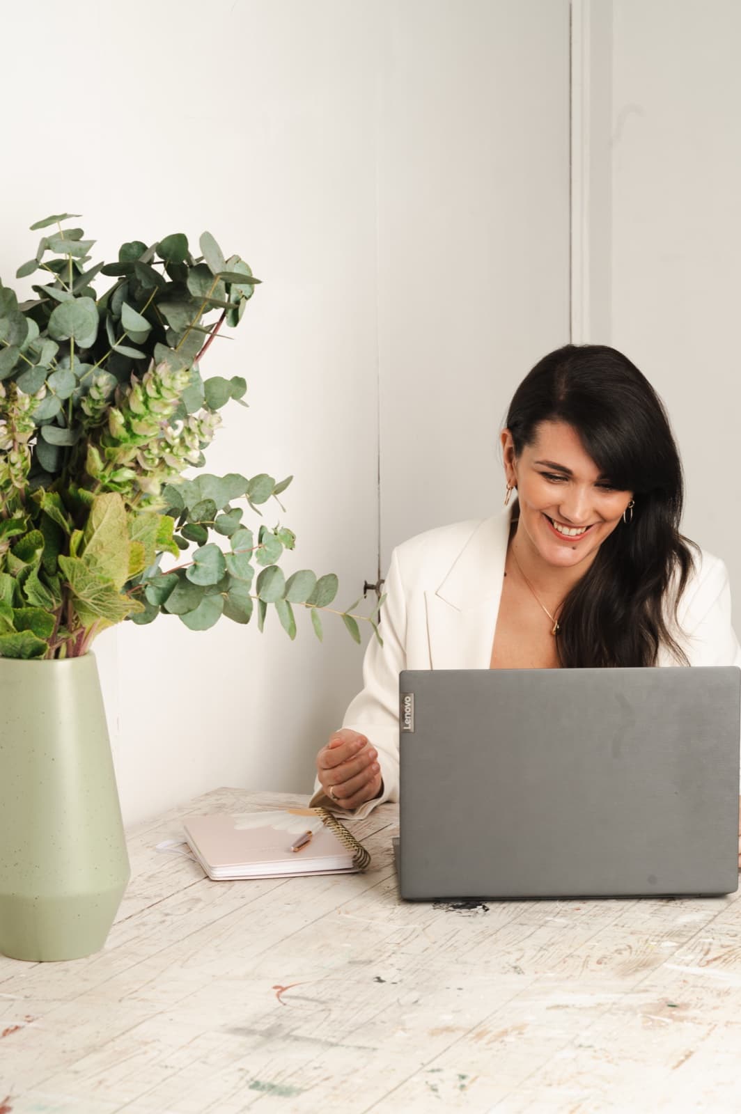 Isabel Fonseca smiling while working at her laptop